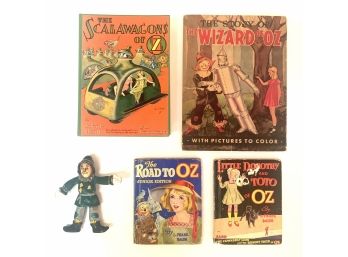 4 Wizard Of Oz Books Together With A Scarecrow Figure.