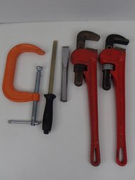 Pipe Wrenches A Clamp  A Sharpening Steel And A Chisel