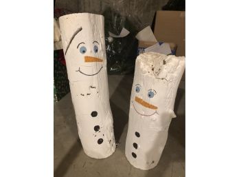 Pair Of Cute Painted Snowmen On Logs