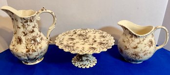 Lot 36- Godinger Brown Toile Pitcher & Small Cake Stand -lot Of 3