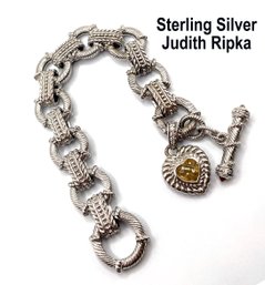 Lot 37 - Judith Ripka Sterling Silver & CZ Bracelet With Dangle Heart Toggle Closure