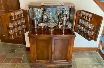 Lot 30- Antique Mahogany Bar Unit On Wheels - Inc Contents -  Crystal Decanters, Drink Mixer, Stemware -
