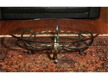Glass Oval Top Coffee Table With Scrolling Brushed Metal Base