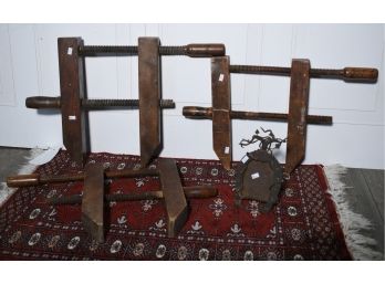 Three Wooden Clamps And A Iron Horseshoe Frame