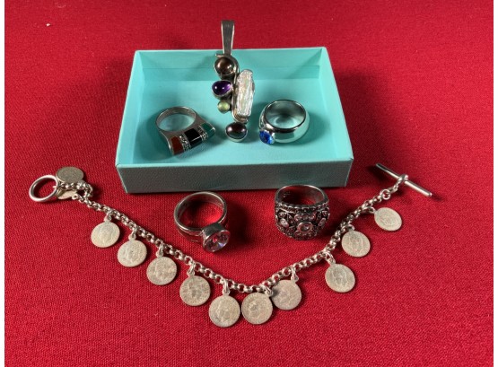 Assorted Sterling Jewelry: Four Rings, Pendant And Charm Bracelet, 53 Grams (CTF10)