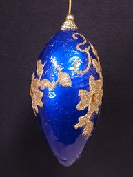 Blue Glass Ornament With Gold Floral Designs And Orange Rhinestones