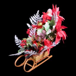 Sled Centerpiece With Flowers And Santa Figurine