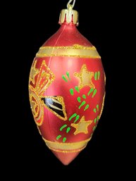 Red Ovoid Glass Ornament Painted With Gold Green And Black Adornments