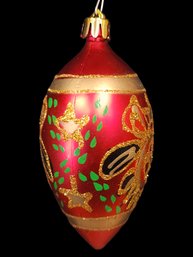 Red Ovoid Glass Ornament Painted With Gold Green And Black Adornments