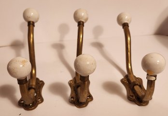 Three Brass Coat Hooks With Porcelain Knobs