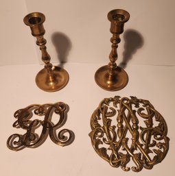 Two Virginia Metal Crafters Trivets And A Pair Of Brass Candlesticks