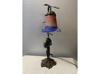 Figural Bronze Table Lamp Of Cherub With Vessel Beneath A Glass Shade