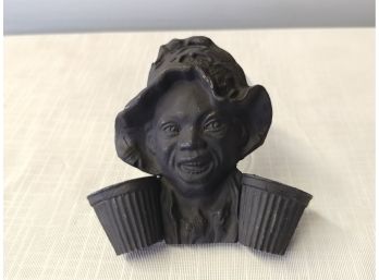 Black Painted Lead Match Holder Depicting Young Man With Cotton Baskets