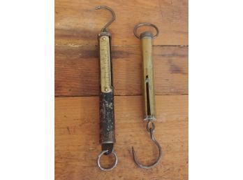 Two Cylindrical Hanging Scales One Brass One Steel