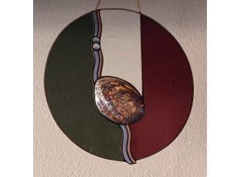 A Beautiful Stained Glass Wall Decoration With An Iridescent Shell In The Middle