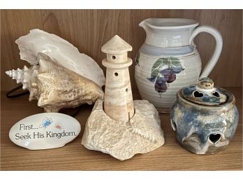 A Collection Of Home Decor Inc. A Light House Light, Conch, And Pottery