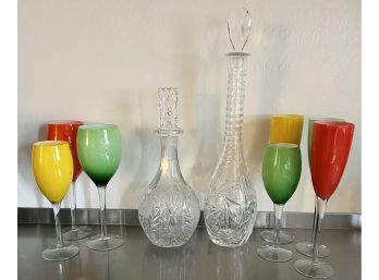 A Fabulous Assortment Of VTG Colored Glasses With 2 Cut Crystal Decanters