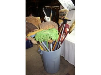 Trash Can Full Of Brooms And Mops, Rake And Shovel