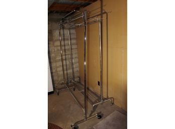 2 Metal Rolling Clothes Racks 60 And 64 In Wide - One Has Bad Caster And Missing Caster