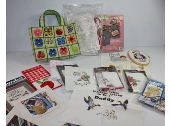 Several Completed Cross Stitch And A Couple Plastic Canvas Kits
