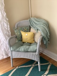 A Soft Water Toned Wicker Chair With Sea Toned Cushion, Pillows & Throw