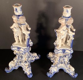 A Pair Of Meissen Candlesticks With Putti, Flowers And Leaves