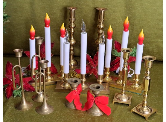 A Variety Of Brass Candleholders And Electric Candles