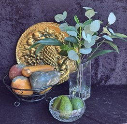 Metal Bowl W/ Clay Fruit, Crystal Bowl W/ Faux Avocadoes, Vintage Brass Wall Hanging & Faux Plants In Vase