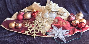 A Red And Gold Christmas With Tree Skirt And Ornaments