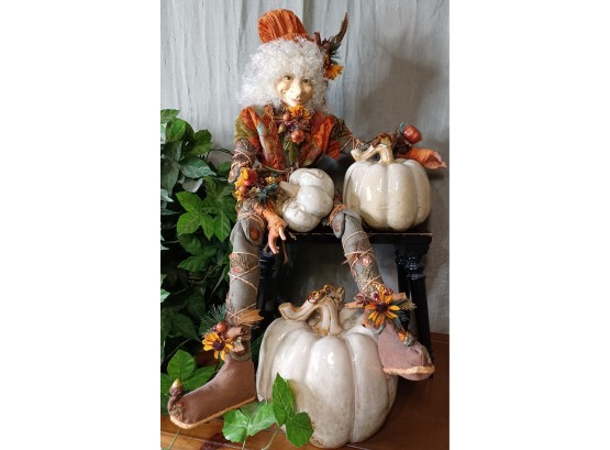 Elf Seated On Black Stool With 3 Ceramic Pumpkins