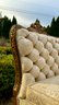 A Curved Tufted Settee