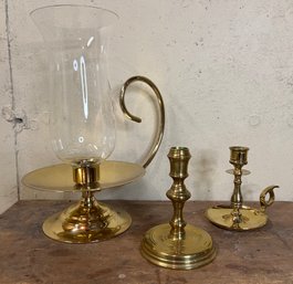 A Collection Of Brass Candle Holders