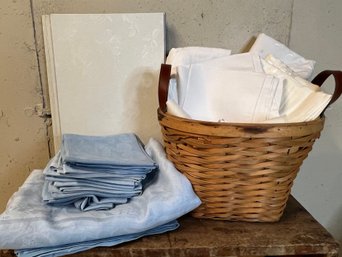 A Basket Of Linens A Tablecloth And Napkins