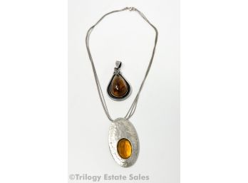 Two Modernist Sterling Silver And Amber Pendants
