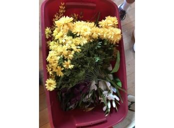Variety Of Faux Flowers In Red Bin