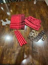 Red Cloth Napkins, Red Candles, Assorted Napkin Rings, And Glass Candlestick Holders