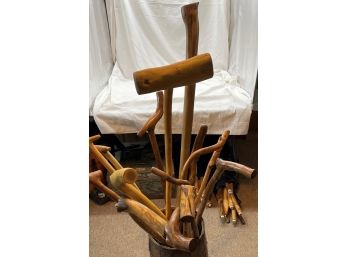 Assorted Walking Sticks Of Varying Lengths In Wooden Barrel