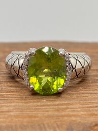 2.28ct Oval Manchurian Peridot With .07ctw Round White Zircon Sterling Silver Ring - Size 4.75