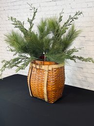 Decorative, Repurposed Woven Wooden Backpack Basket With Faux Conifer Greens