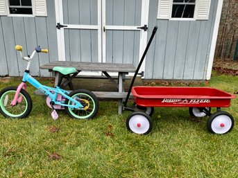Childs Picnic Table With 100th Anniversary Radio Flyer Wagon And Childrens Bike