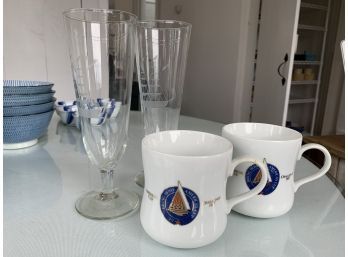 Lot Of Pair Of Americas Cup Mugs And Pair Etched Sailboat Pislner Glasses