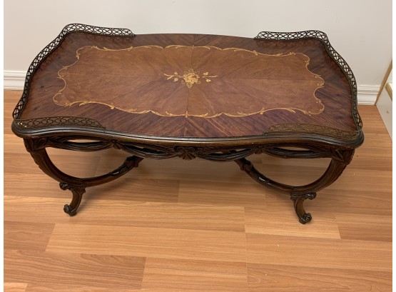 Antique Wood Coffee Table With Carved Legs And Flower Inlay And Brass Rim