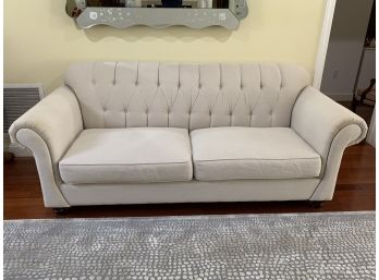 Sand Colored Couch With Button Tuft Back And Rolled Arms