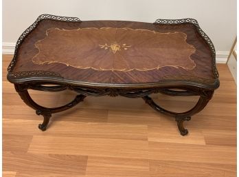 Antique Wood Coffee Table With Carved Legs And Flower Inlay And Brass Rim