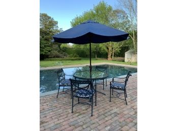 Round Wrought Iron Patio Table With Glass Top With 4 Kettler Armchairs With Navy Umbrella