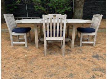 Outdoor Designs LTD Oval Teak Patio Table With 4 Matching Side Chairs With Navy Cushions