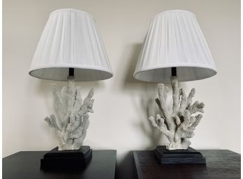Pair Of Coral Lamps With White Pleated Shades On Dark Wood Base