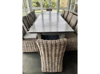 Long Patio Table With Grey Metal Wrapped Top And Teak Legs  With 12 Rattan Chairs With Grey Cushions