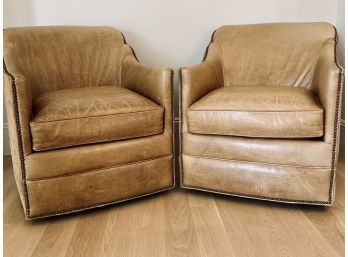 Pair Of Tan Leather Master Swivel Barrel Chairs With Nailhead Detail And Pony Hair Backs