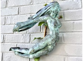 Bronze Female Form Sculpture Hanging On The Wall Outside